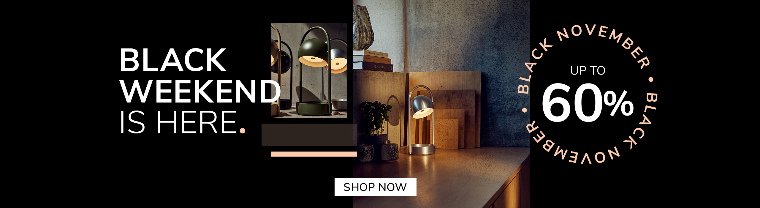 Modern silver table lamp glowing on a wooden desk with cutting boards and plants in the background. Promotional text reads: ‘Black Weekend is here. Up to 60%. Black November.’ A button says ‘Save Now.’